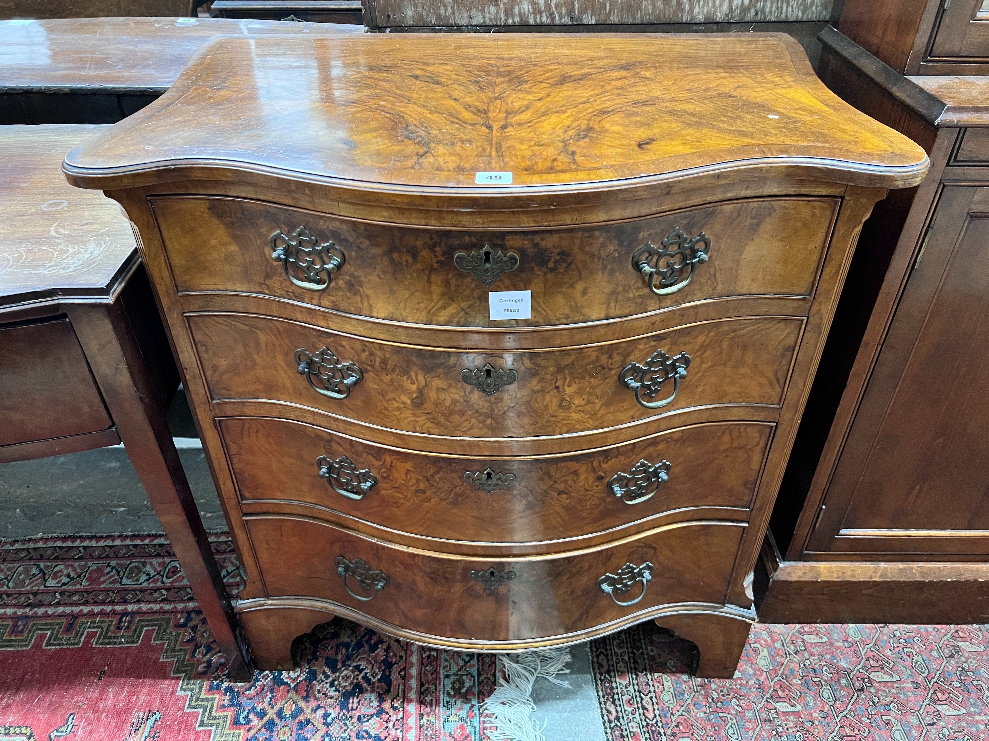 A George III style walnut serpentine fronted chest, fitted four long graduated drawers, width 82cm, depth 53cm, height 86cm *Please note the sale commences at 9am.